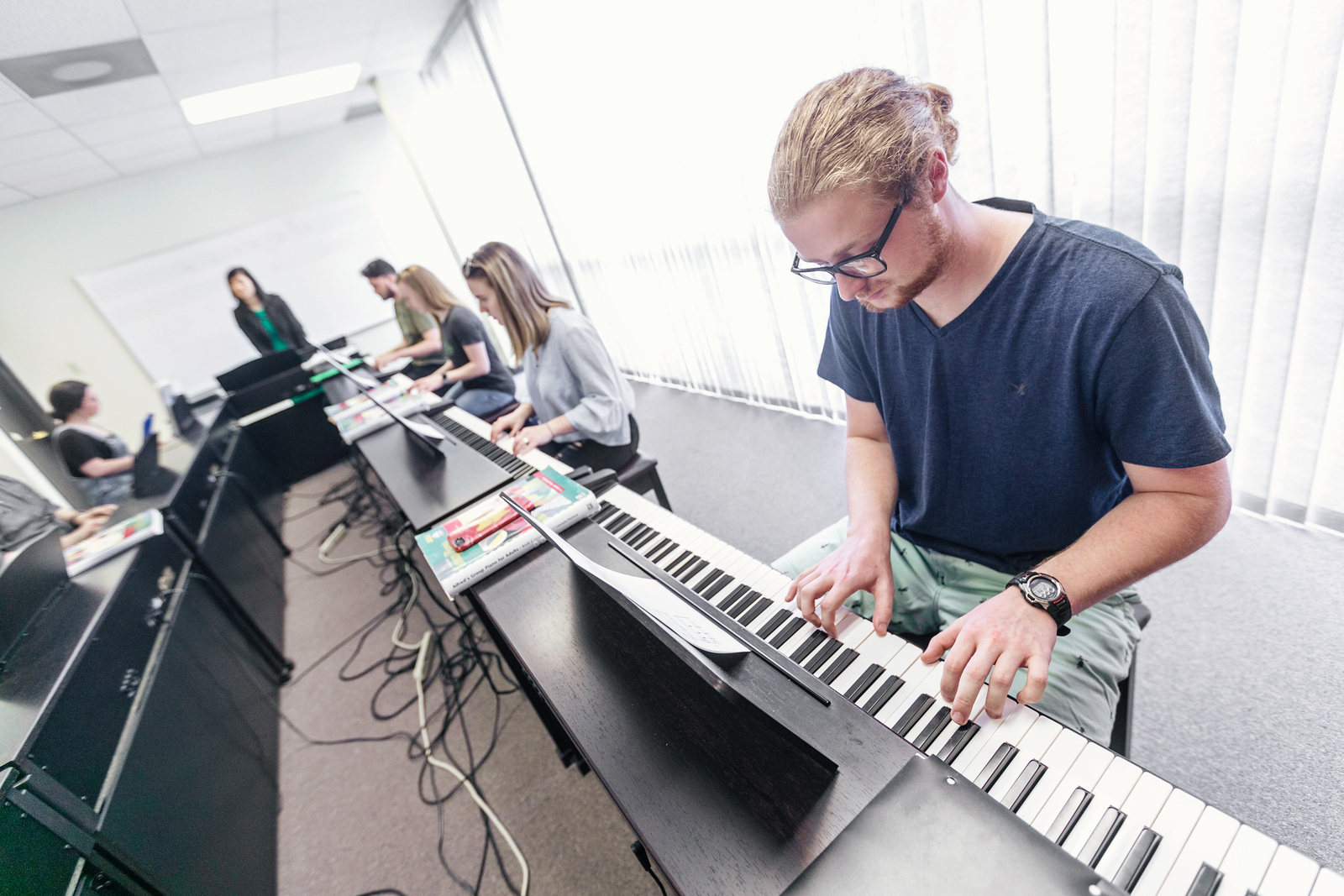 student practicing keyboard in class