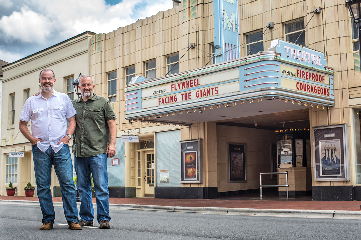 Alex and Stephen Kendrick pose outside the Gem Theater in Kannapolis, N.C., after filming scenes for “War Room,” the top-selling movie in the nation over Labor Day weekend.