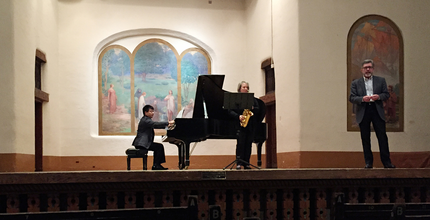Dr. Patrick Houlihan, at right, presents his “Snoqualmie Passages” at the joint national conference of the College Music Society and the National Association of College Wind and Percussion Instructors; it was performed by Dr. Lei Cai, on piano, and Dr. Caroline Taylor, on saxophone.
