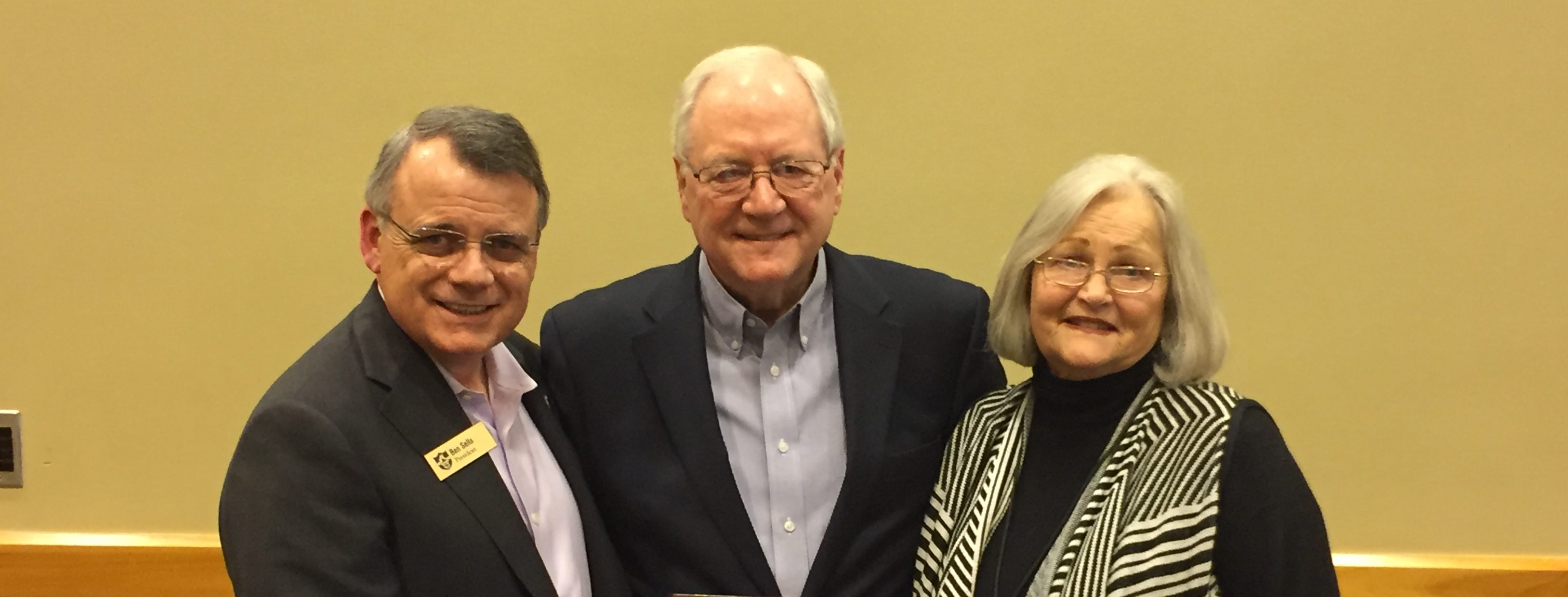 Dennis Wilkins (center), seen here with his wife, Marsha, was presented with the ABSC Associational Missionary of the Year award by Ouachita Baptist University President Ben Sells (left).