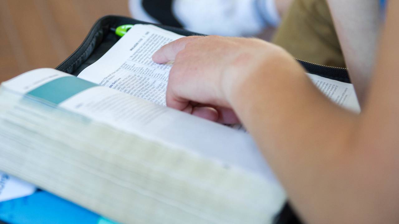Student reads open Bible