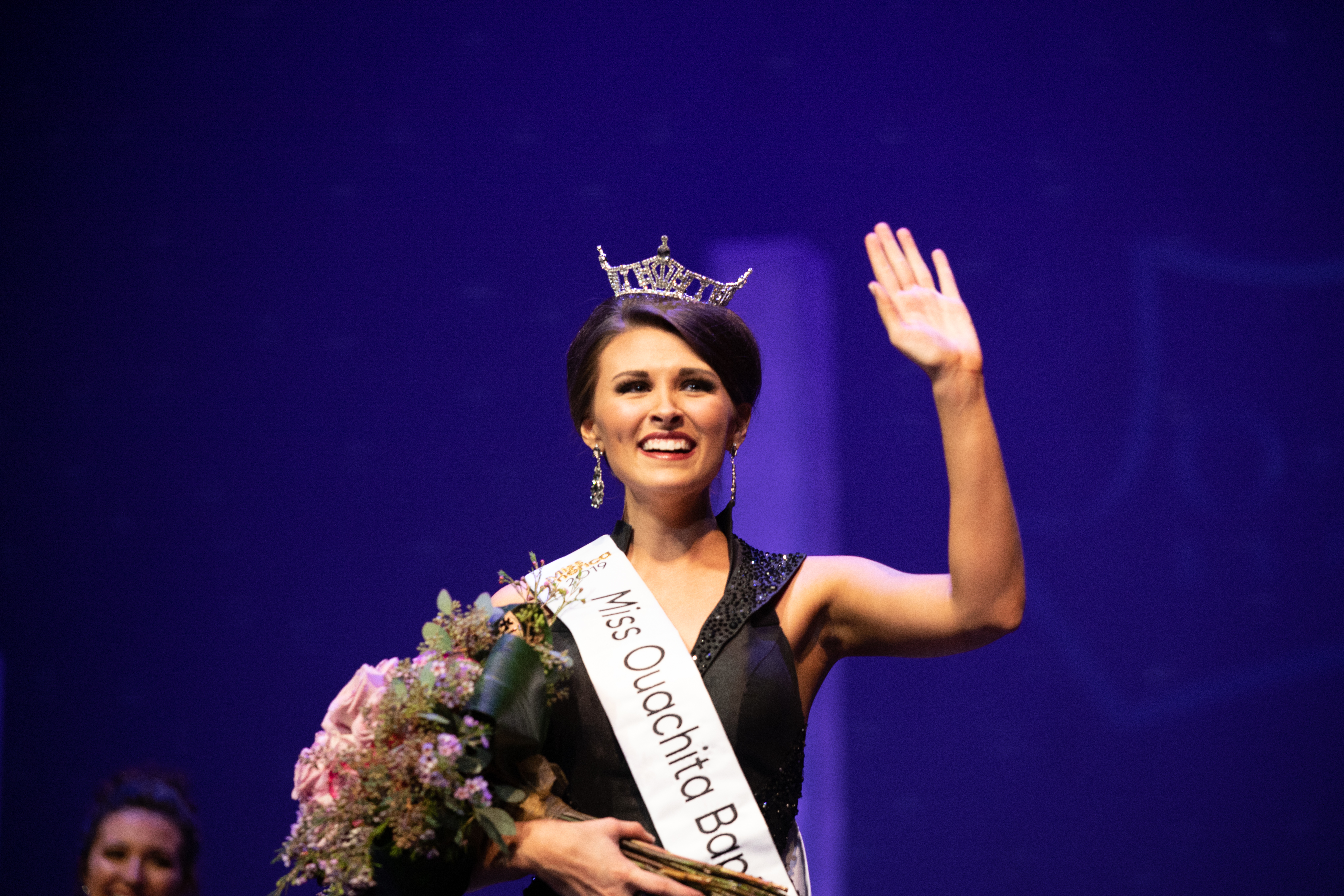 Miss OBU 2019, Julie Williams, celebrates her win in 2019 and waves to the crowd