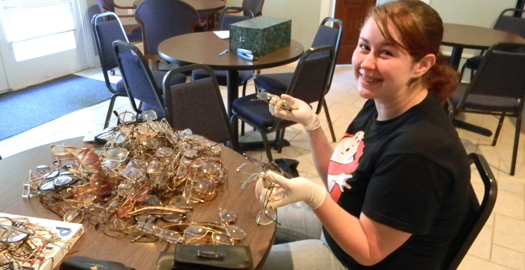 Ouachita student Sandy Robinson sorts and counts donated glasses.